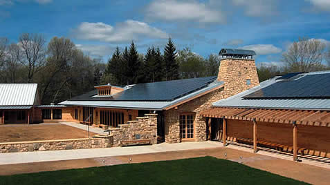 photo of a building in stone, solar panels in evidence